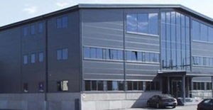 Large industrial warehouse of NPA Nordiskt Papper AB in Kungsängen, Sweden, used for paper product storage and logistics.